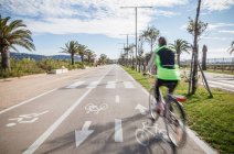Rear view of cyclist wear high cycling in lane — Stock Photo