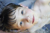 Close up portrait of boy in river — Stock Photo