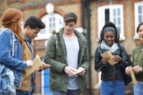 Young adult college students opening exam results on campus — Stock Photo