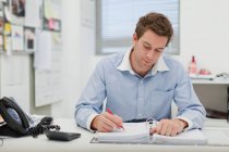 Businessman working at desk — Stock Photo