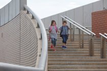 Children climbing stairs outdoors — Stock Photo