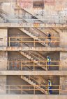 Workers climbing steps on dry dock — Stock Photo