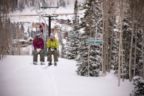Skifahrer fahren Sessellift über Piste — Stockfoto