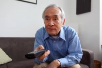 Older man watching television — Stock Photo