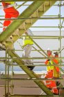 Workers climbing steps on site, selective focus — Stock Photo