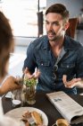 Man in restaurant chatting with friend — Stock Photo
