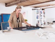 Designer printing on textiles in studio — Stock Photo