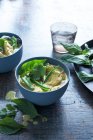 Bowl of soup with vegetables and herbs — Stock Photo