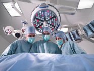 Group of surgeons operating in theatre — Stock Photo