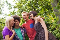 Group of young adult friends in garden — Stock Photo