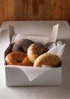 Box of various bagels with seeds and poppy — Stock Photo