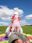 Father and baby in field — Stock Photo