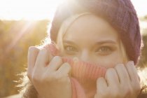 Ritratto di giovane donna con cappello in maglia, bocca coperta — Foto stock