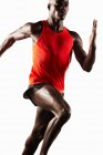 Männlicher Athlet läuft auf weißem Hintergrund — Stockfoto