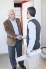 Architects shaking hands in office — Stock Photo