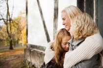 Mother and daughters sitting outdoors — Stock Photo