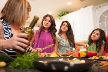 Women cooking together in kitchen — Stock Photo