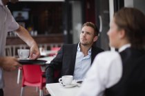 Business people having coffee together — Stock Photo