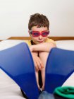 A boy wearing goggles and flippers — Stock Photo