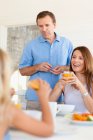Family eating together at table — Stock Photo
