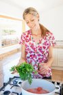Woman cooking in kitchen — Stock Photo