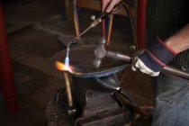Blacksmith at work in shop, cropped view — Stock Photo