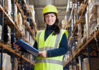 Worker holding clipboard in warehouse — Stock Photo