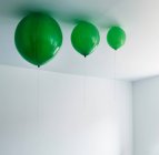 Green balloons on ceiling — Stock Photo