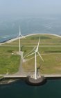 Aerial shot of two wind turbines mounted on Oosterschelde flood barrier, Vrouwenpolder, Zeeland, Países Bajos - foto de stock