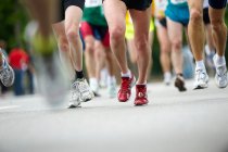 Cropped shot of people running marathon — Stock Photo
