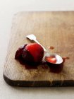 Stewed plum and juice on board — Stock Photo