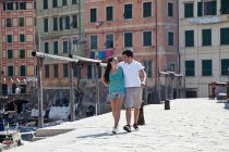 Couple walking along urban pier — Stock Photo