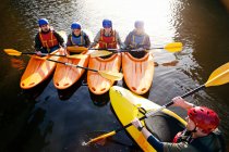 Teacher talking to students in kayaks — Stock Photo