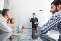 Businesswoman presenting to colleagues — Stock Photo