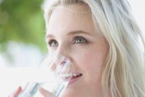 Portrait of woman drinking water — Stock Photo