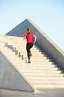 Woman running on staircase — Stock Photo