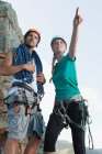 Climbers surveying mountaintop, selective focus — Stock Photo