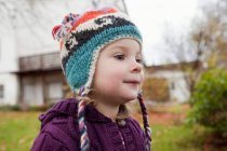 Portrait of girl in knitted cap outdoors — Stock Photo