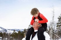 Grandson and grandfather smiling — Stock Photo