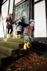 Boy jumping from doorstep — Stock Photo