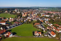 Aerial view of village rooftops and green fields — Stock Photo