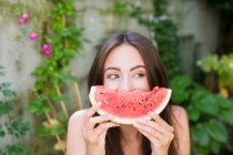 Smiling woman playing with watermelon — Stock Photo