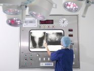 Nurse with x-rays in operating theatre — Stock Photo