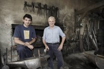 Portrait of blacksmiths in workshop — Stock Photo