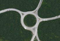 Aerial view of rural roundabout surrounded with green trees — Stock Photo