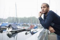 Portrait of young man in marina — Stock Photo