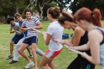 Friends playing tug of war in park, selective focus — Stock Photo