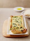 Plate of leek and spinach tart served on table — Stock Photo
