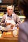 Uomo con campioni gratuiti in negozio di alimentari — Foto stock