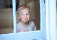 Kleinkind-Mädchen im Diadem macht Gesicht, Fokus auf Vordergrund — Stockfoto